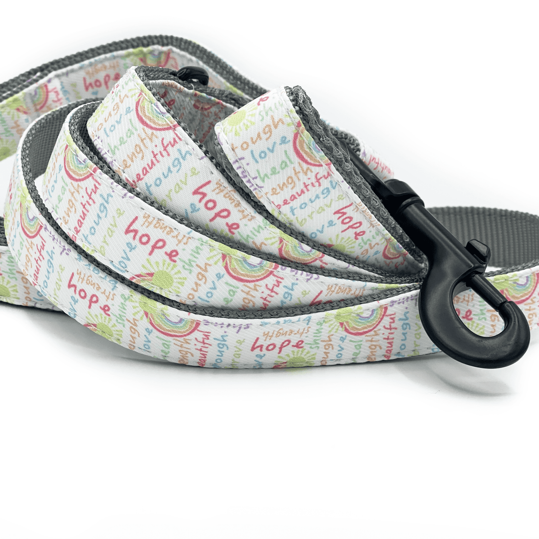 a dog leash with happy and positive words in a rainbow of colors
