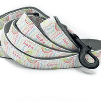 a dog leash with happy and positive words in a rainbow of colors