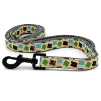 a multi-colored frog patterned dog leash with a black clasp