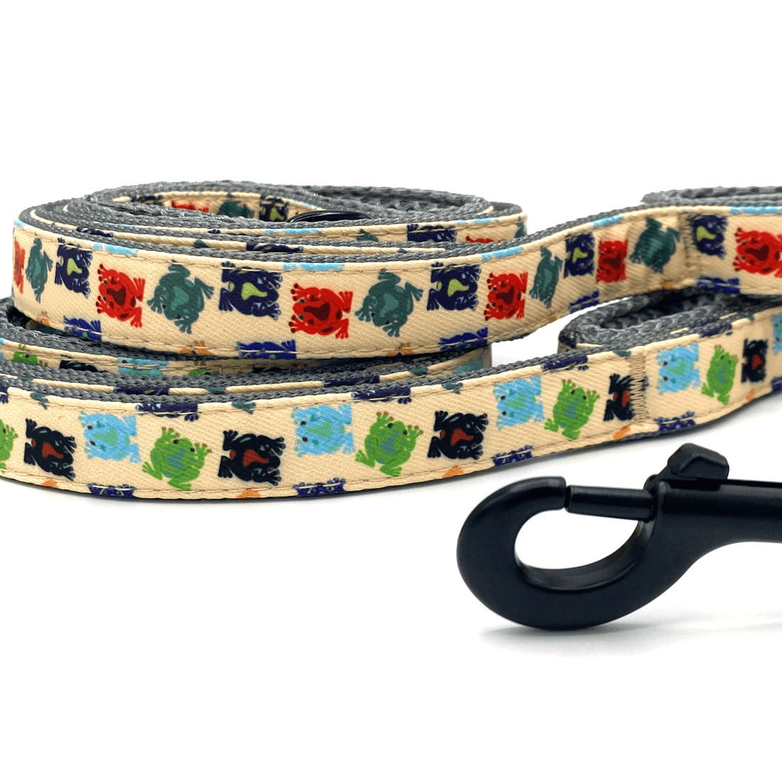 two frog patterned leashes with black clasp and grey padded handles