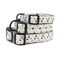 3 collars stacked on top of one another all with a paw print pattern
