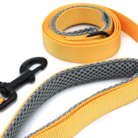 a dark yellow/orange leash closeup photo featuring the grey mesh handles and black hardware