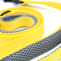 a bright yellow dog leash closeup photo with grey mesh handles for padding