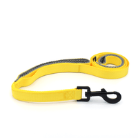a bright yellow dog leash with light grey padding in the handles and black hardware